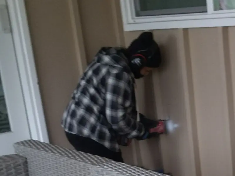 Professional electrician installing an exterior outlet in Lenox
