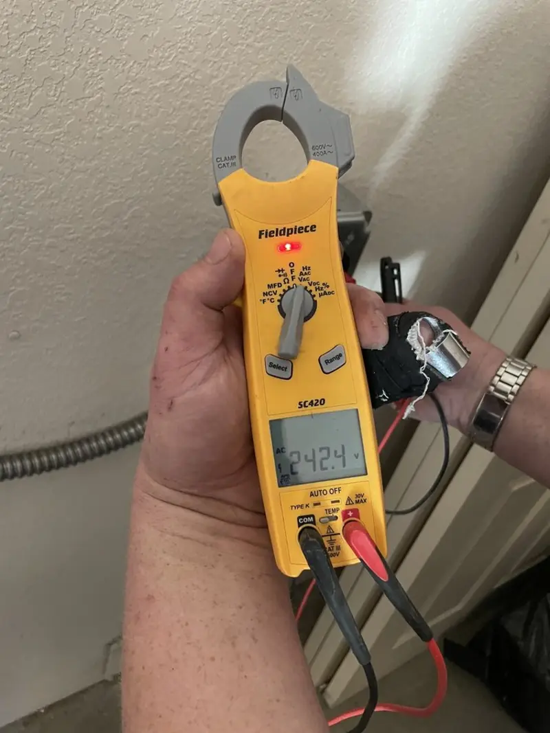 Voltage testing with clamp meter during Ceiling Fan Installation in Lenox